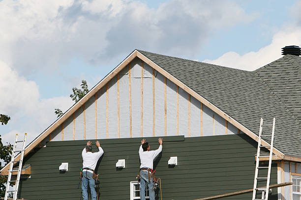 Professional Storm Damage Siding Repair technician working in Warnock, OH